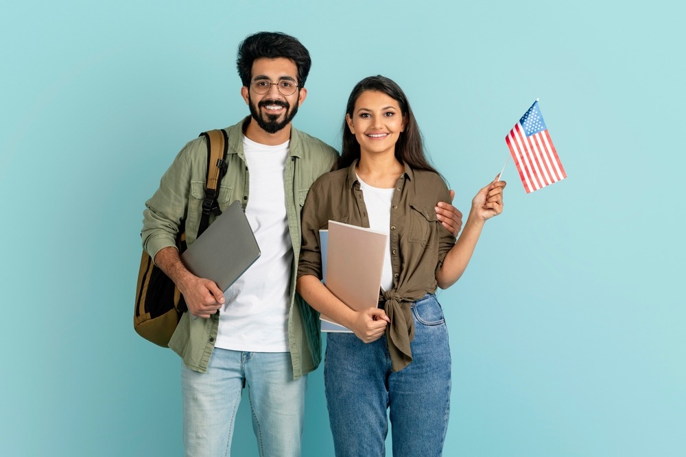 Immigrant couple weaving an American Flag. Who Are the Principal Applicant and Derivative Applicant?