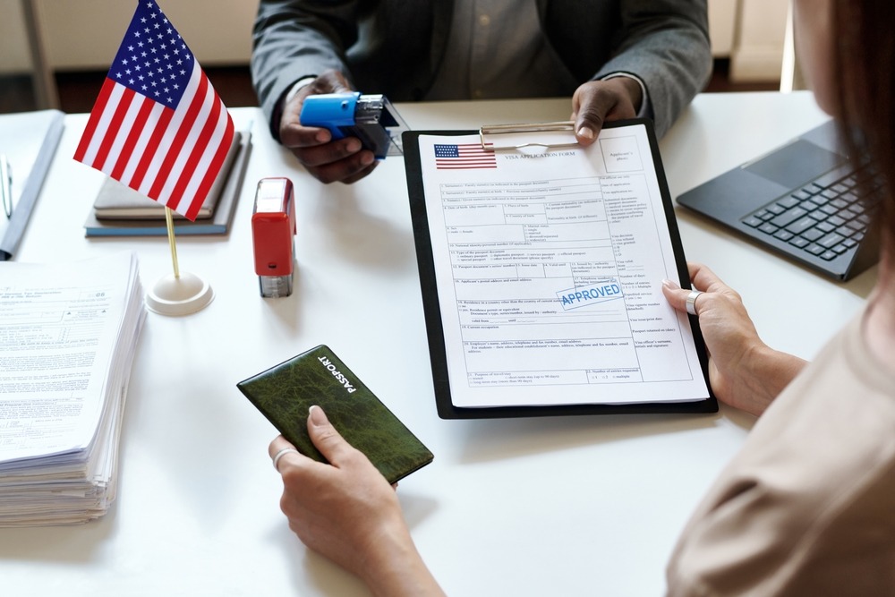 Woman getting her international documents. What happens after NVC accepts documents?