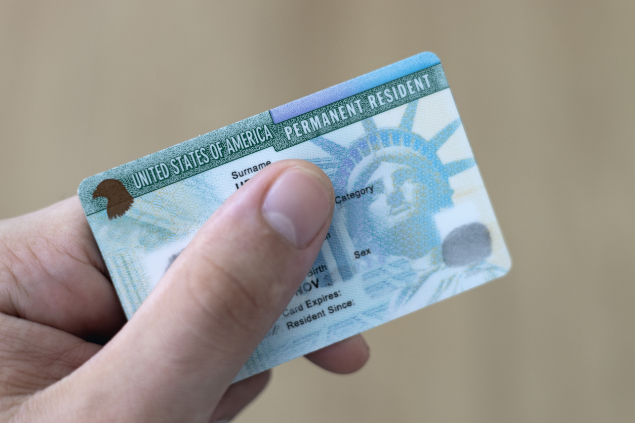 Person holding a green card