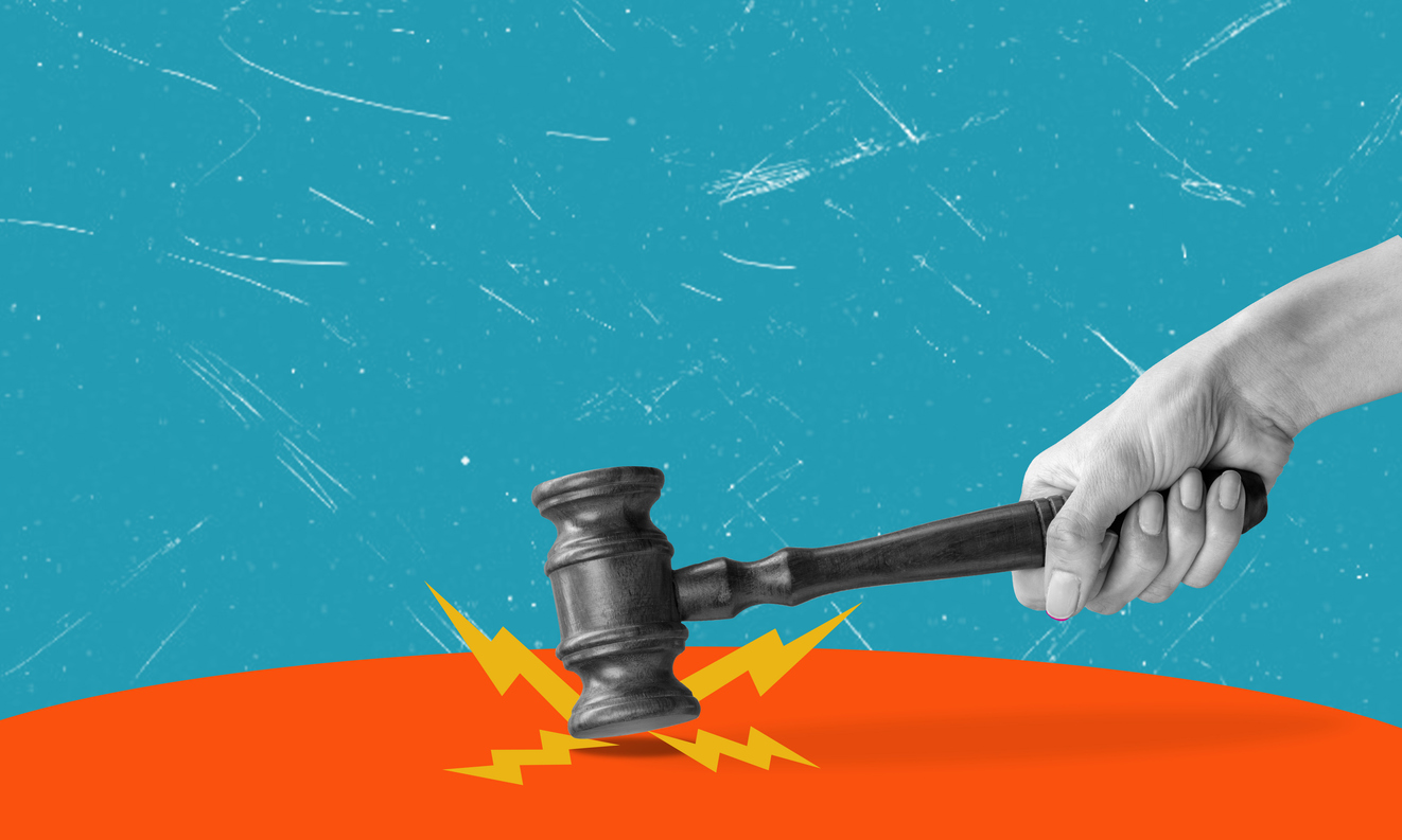 Hand slamming a gavel onto an artistic background